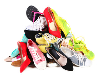 Pile of various female shoes isolated on white