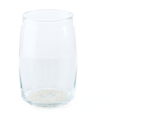 Remnants of rice in glass jar isolated on white