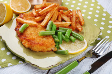 Breaded fried fish fillets and potatoes with asparagus and