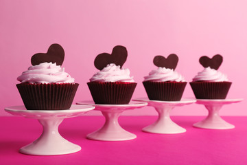 Delicious Valentine Day cupcakes on pink background
