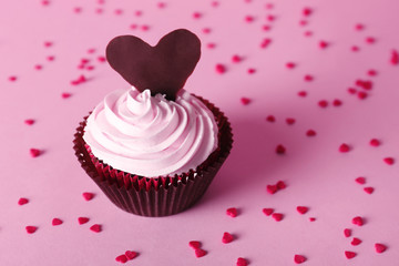 Delicious Valentine Day cupcake on pink background