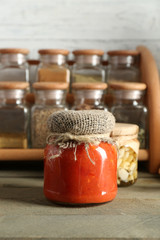 Different spices canned vegetables in glass bottles