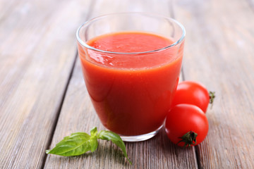 Tomato juice in glass with basil  and tomatoes cherry