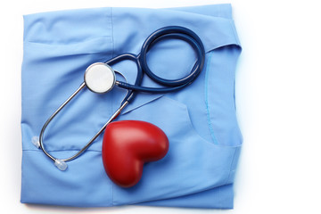 Stethoscope with heart on suit background, close-up