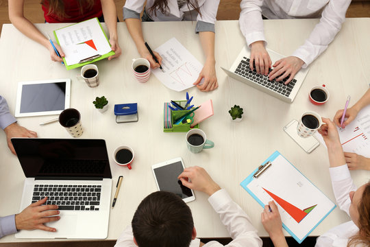 Group Of Business People Working At Desk Top View