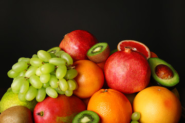 Fototapeta na wymiar Assortment of fruits on black background