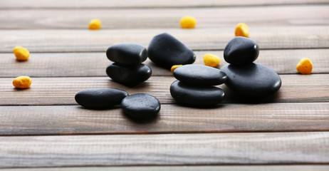 Spa stones drops on wooden background