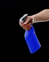 Male hand with sprayer on black background