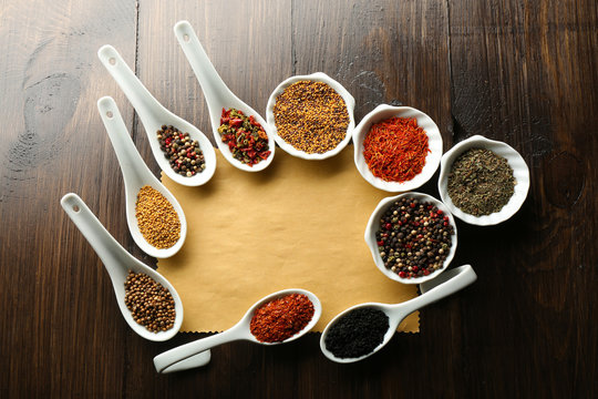 Different kinds of spices in bowls and spoons
