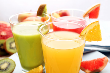 Fresh juices with fruits on wooden table