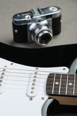 Black and white guitar frets with vintage photo camera