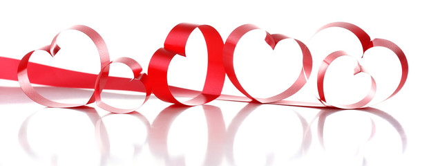 Red ribbons in shape of hearts isolated on white