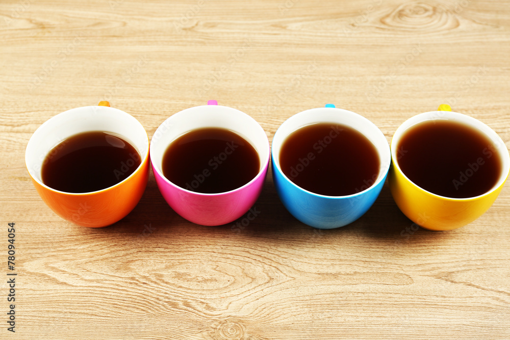 Sticker Cups of coffee on wooden table background