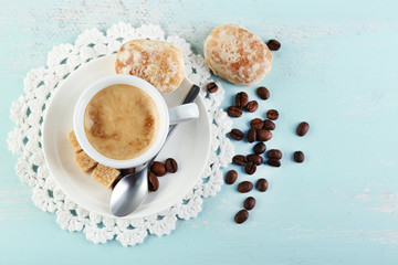 Obraz na płótnie Canvas Cup of coffee and tasty cookie on color wooden background
