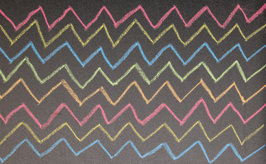 Hand drawn zig zag lines on chalkboard background