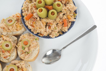bread with tuna salad topping and olives