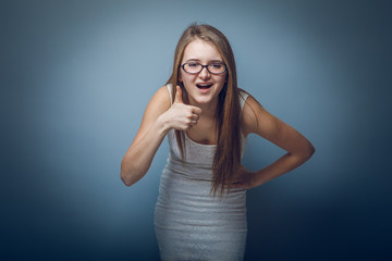 European appearance blonde girl with glasses shows sign and the