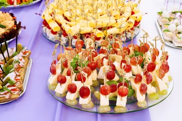 red grapes and cheese canapes on a plate