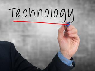 Businessman hand writing technology in the air. Grey background