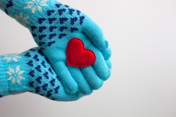 Read heart in hands in  warm  gloves for Valentine's Day