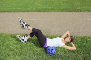 A Roller skating girl in park rollerblading on inline skates.