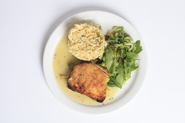 A Grilled chicken fillet, rise and salad with it.