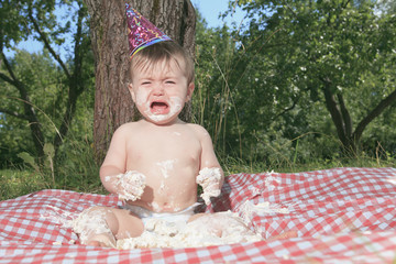 Baby girl celebrating her first bithday with gourmet cake