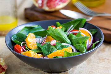 Orange with spinach and pomegranate salad