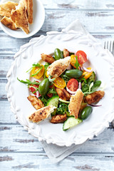 Chicken salad with naan bread and olives