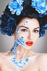 Beautiful young girl with blue flowers