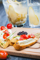 traditional Spanish tapas with cheese and tomatoes on a wooden