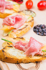 traditional Spanish tapas with slices of hamon and melon on a
