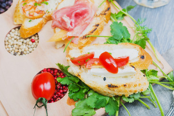 mix of traditional Spanish tapas on a wooden plate with decor