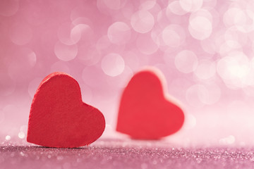 Obraz premium Red hearts over abstract glitter background