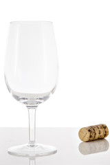 Empty red wine glass and wine bottle cork