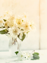 Naklejka na ściany i meble Jasmine flowers in a glass vase
