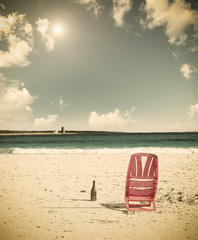 chair and beer at the beach under the sun in vintage effect