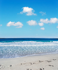 shoes footprints in the sand by the shore