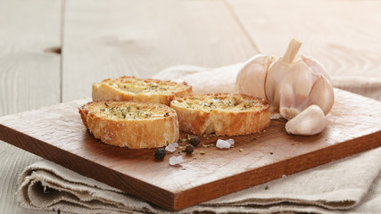 crostini with olive oil and garlic, on cutting board