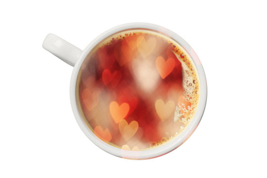 Double exposure of coffee cup and heart shaped defocused lights.