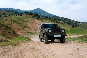 Fototapeta na wymiar Car on the road in Tien-Shan mountains