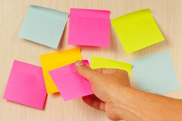 Hand sticker sticks on a wooden message board