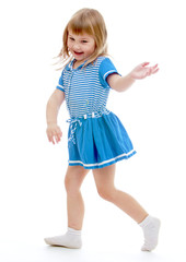 Cheerful girl in a summer short blue dress.