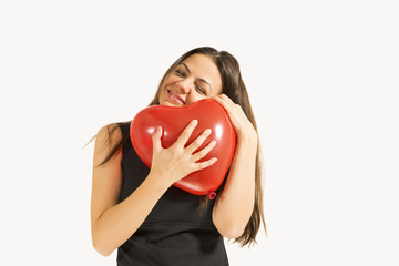 Woman with red heart balloon on a white background.