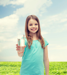 smiling little girl giving glass of water