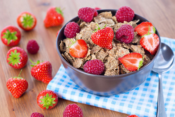 Bran flakes with fresh raspberries and strawberries