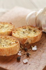 crostini with olive oil and garlic, on cutting board