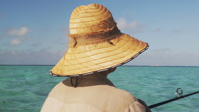 man with hat on boat in Mauritius