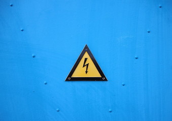 Yellow Electrical Warning Triangle Sign on Blue Background