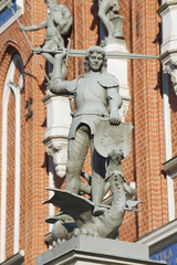 Obraz premium Statue of the knight defeating a dragon in Riga, Latvia.
